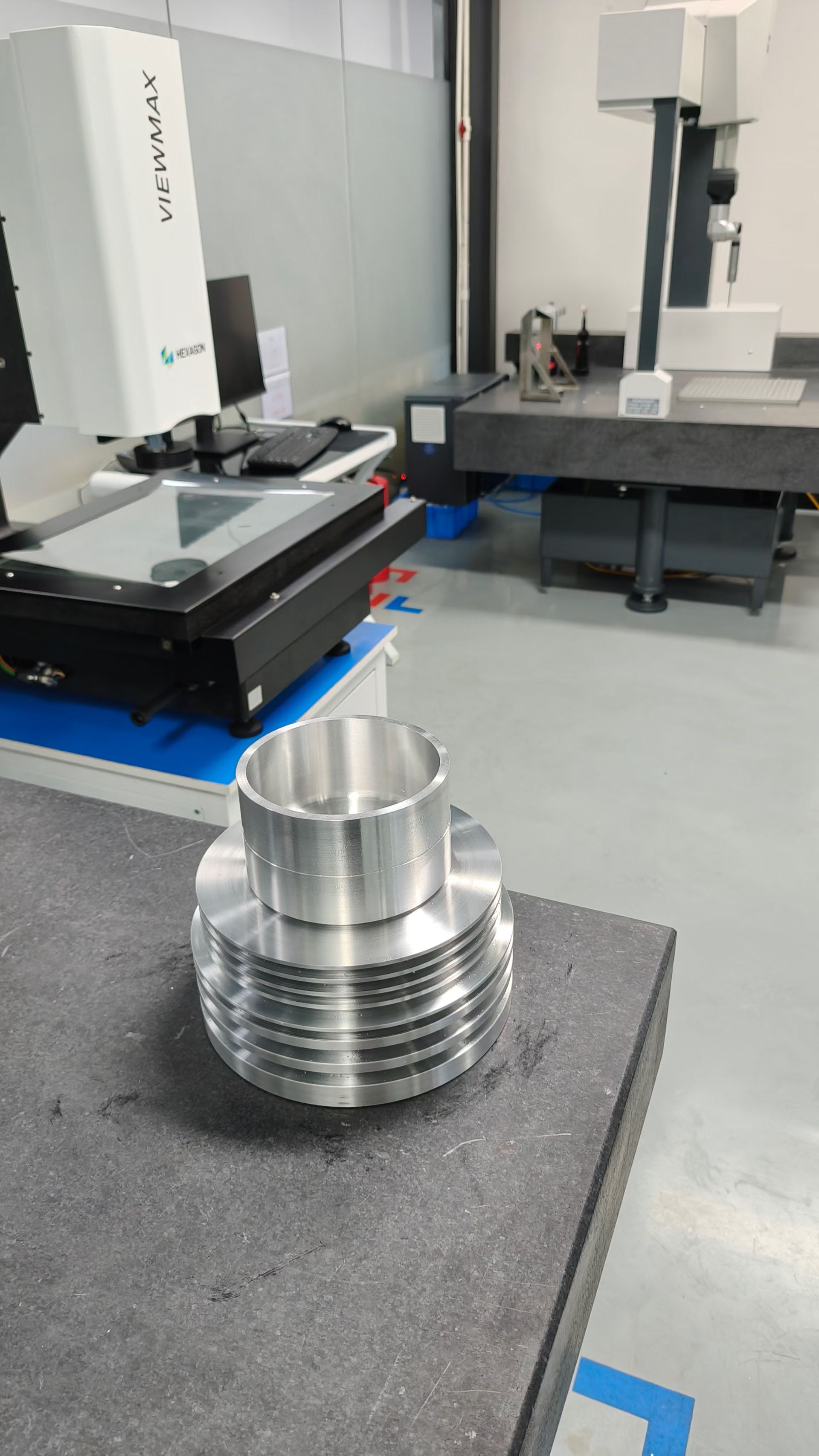 Machined component positioned in an inspection room with measurement equipment